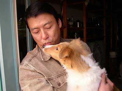 Dog days in China
Xu Zhang's collie Jason is close to being oversize and subject to confiscation by Beijing police. 'I'm worried,' he says. Under regulations that take effect Monday, small breeds have been granted full legitimacy. Medium-sized and large dogs have been targeted for a crackdown.
(Tribune photo by Michael A. Lev)
December 1, 2003